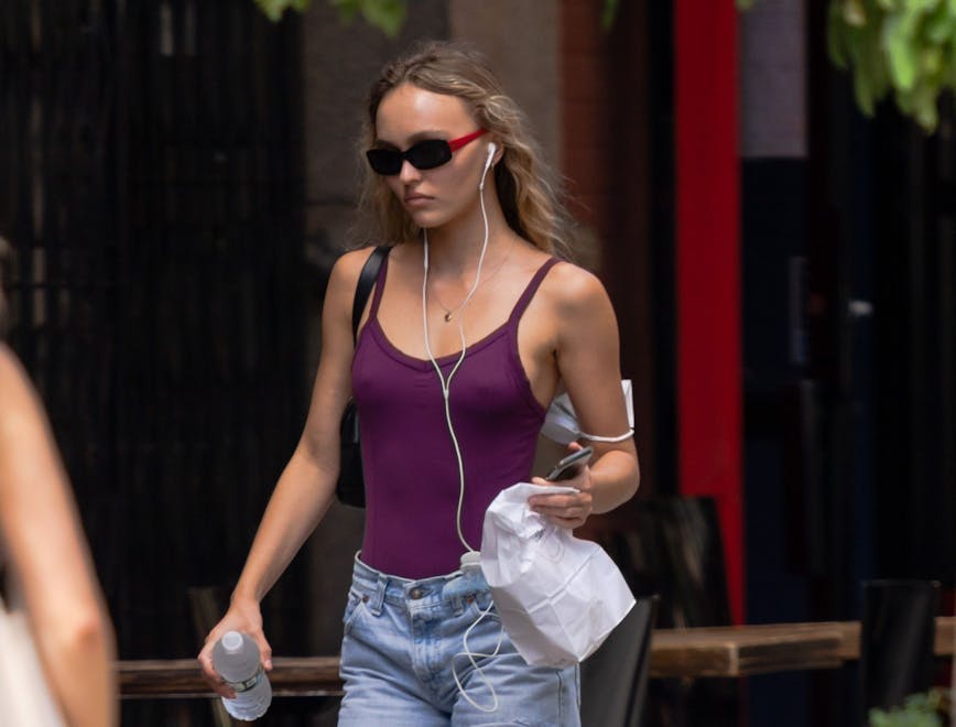 new york clothing shorts pedestrian person bag handbag glasses shoe vest mobile phone